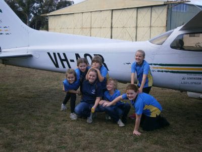 Girl Guides in front of a Scouts NSW plane