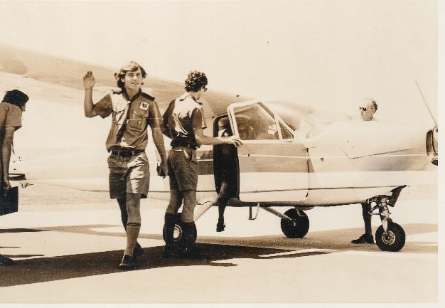 Old photo of Scouts next to a plane
